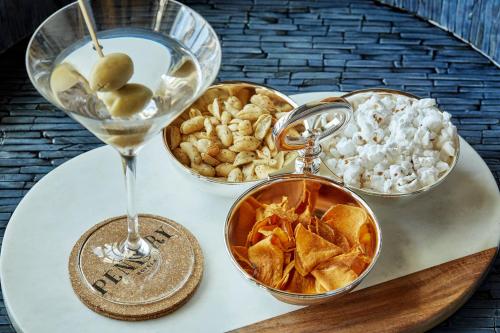 a table topped with bowls of food and a wine glass at Pendry San Diego in San Diego