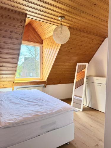 a bedroom with a bed and a window and a ladder at KM APPARTS Wesel 6 in Wesel