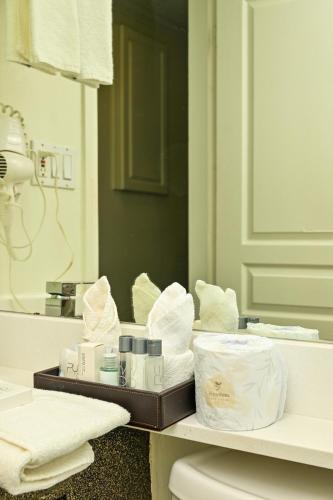 a bathroom with a counter with towels and a mirror at Hotel Opportune in Vancouver