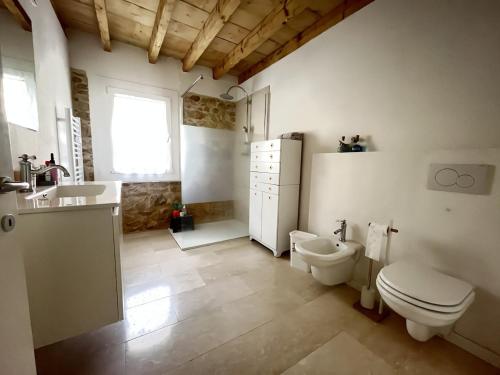a bathroom with a sink and a toilet and a sink at Papiria Residence in Piovene Rocchette