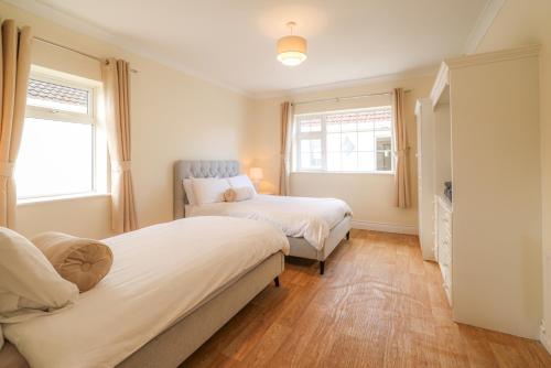 a bedroom with two beds and a tv at Hillside House- Pine View in Ballinamuck