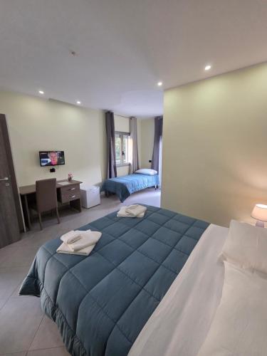 a bedroom with a large blue bed in a room at Hotel Rodian in Acquappesa