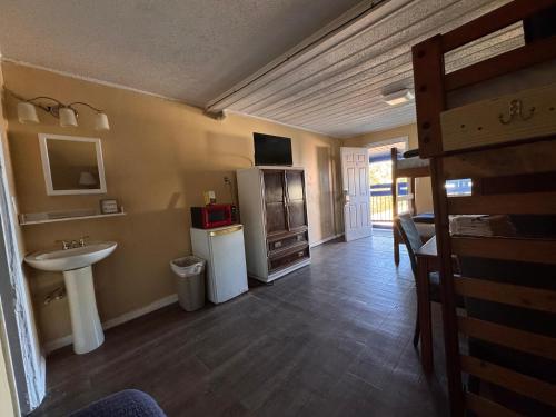 a bathroom with a sink and a refrigerator at CMI Hotel 1935 Myrtle Beach SC in Myrtle Beach