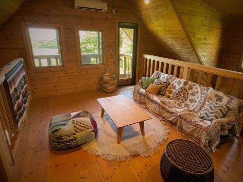 a living room with a couch and a table in a cabin at Minamiboso OSORA - Vacation STAY 56344v in Minamiboso