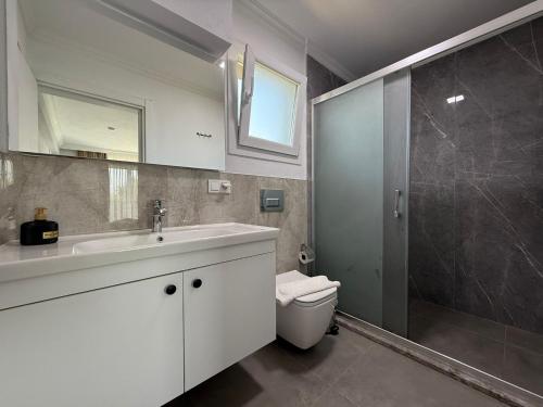 a bathroom with a toilet and a sink and a shower at Villa Atay in Dalyan