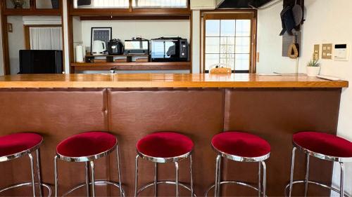a group of red stools sitting at a bar at OURoom UMIBE-Hokota - Vacation STAY 58188v in Hokota