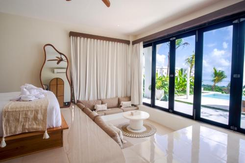 a bedroom with a bed and a view of the ocean at Villa Kai Nusa Penida in Sampalan