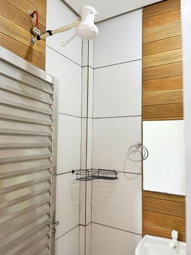 a bathroom with a shower with a ceiling fan at Pousada Elizium in Montes Claros