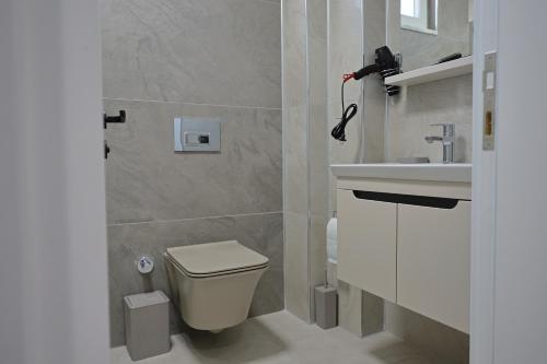 a bathroom with a toilet and a sink at Vıllaozden in Belek