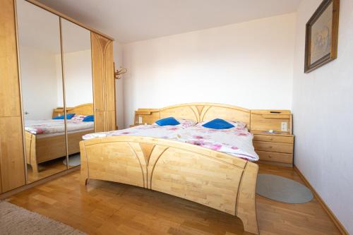 a bedroom with a wooden bed and a mirror at Ferienhaus Englbrecht in Krispl