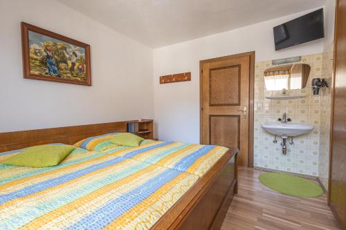 a bedroom with a bed and a sink at Ferienhaus Englbrecht in Krispl