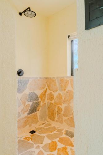 a room with a stone wall and a door at Makáry Beach Tolú by Bernalo Hotels in Tolú