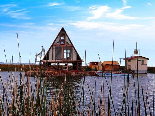 a small house in the middle of a body of water at Jutma Titicaca Lodge in Puno