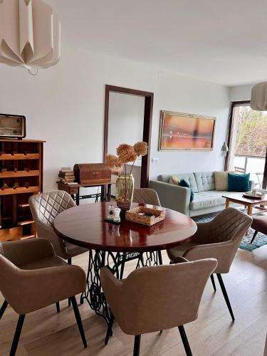 a living room with a table and chairs at Erkel 19 Apartmanház in Keszthely