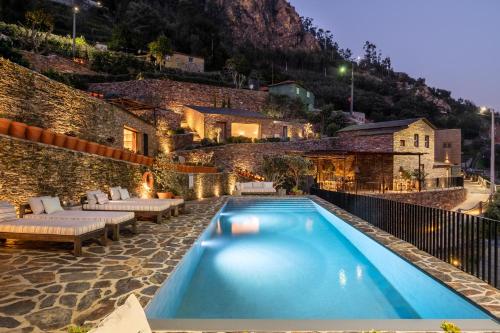 a swimming pool in the middle of a building at DOURWIN Exclusive Suites & Restaurant - Adults Only in Penafiel