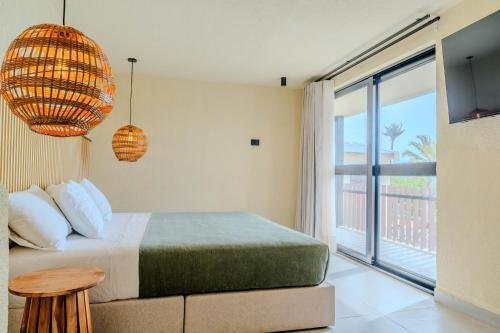 a bedroom with a bed and a balcony at Makáry Beach Tolú by Bernalo Hotels in Tolú