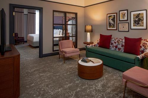 a living room with a couch and a bed at The Eliza Jane, Autograph Collection in New Orleans