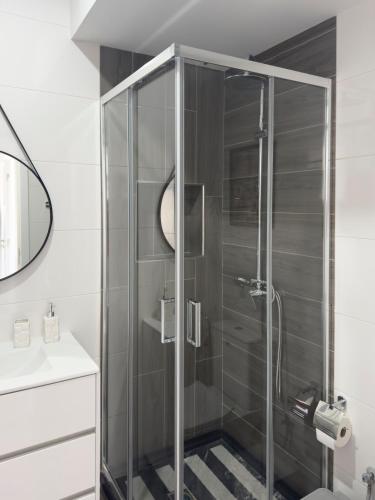 a shower with a glass door in a bathroom at Modern 2-bdr apt with rooftop pool - LCGR in Praia