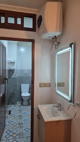 a bathroom with a sink and a toilet and a shower at Maison marhaba2 app 3 in Agadir