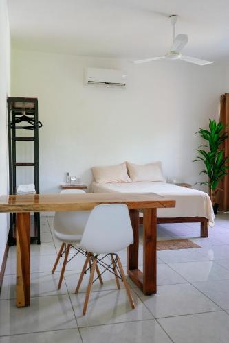 a bedroom with a wooden table and a bed at Casa Mura in Puerto Escondido