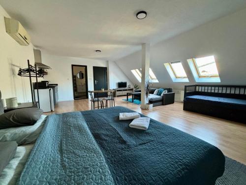 a bedroom with a large bed and a living room at Apartmán Gabi in Lučenec