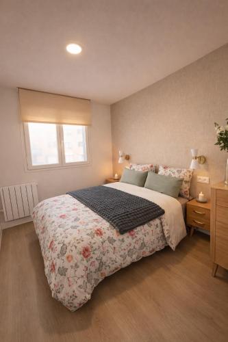 a bedroom with a large bed and a window at Casa Cuca O Grove in O Grove