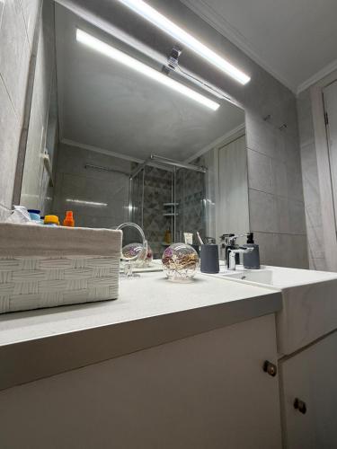 ein Badezimmer mit Waschbecken und Spiegel in der Unterkunft Kampos View in Ágios Nikólaos
