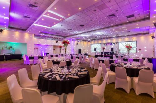 a banquet hall with tables and chairs and purple lighting at Best Western Premier Marina Las Condes in Santiago