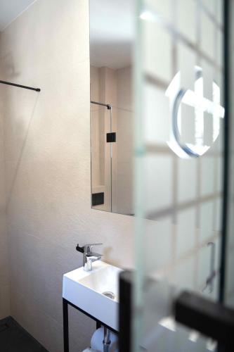 a bathroom with a sink and a mirror at Villa Aria in Krynica Zdrój