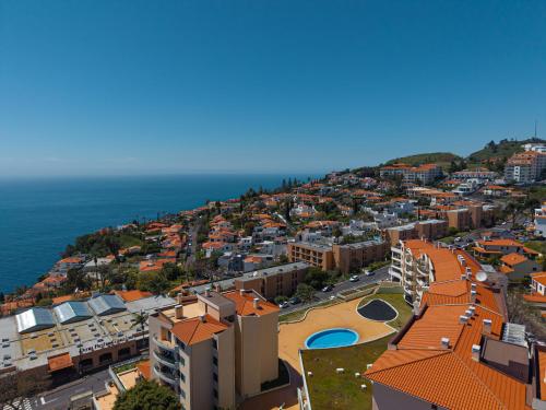 an aerial view of a city with buildings and the ocean at Garajau Terrace Apartment - Pool and Free Parking in Caniço