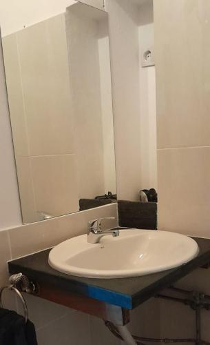 a bathroom with a white sink and a mirror at Quinta Da Lagoa GuestHouse in Vila Real