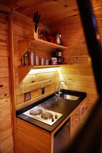a kitchen with a sink and a stove at WANDER CABINS Valle de Bravo in Valle de Bravo