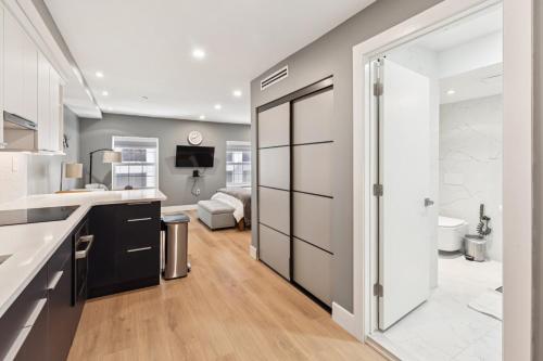 a kitchen with a sliding door leading to a living room at 24 Stay - Philadelphia Rittenhouse in Philadelphia