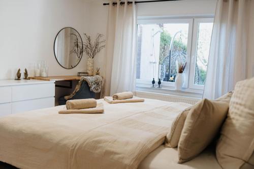 a bedroom with a large bed with two pillows on it at Garden Spa Suite - Private Sauna & Whirlpool in Betzdorf