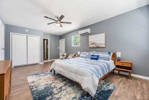 a bedroom with a bed and a ceiling fan at Ocean Blue Heated Pool Home in Largo