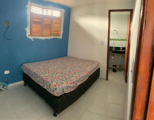 a bedroom with a bed in a blue room at Casa em jacuma vip in Conde