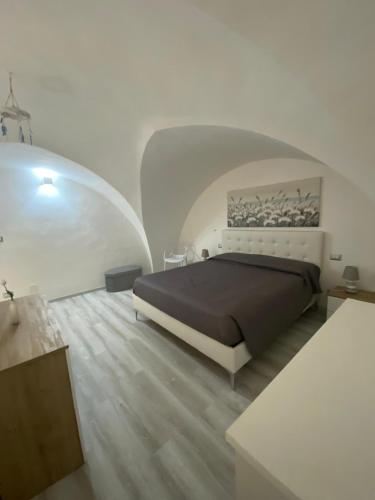 a bedroom with a large bed in a white room at Nardò apartment in Nardò