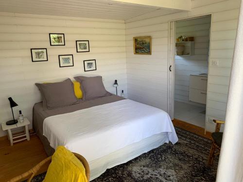 a bedroom with a bed and a walk in shower at Cabane dans la verdure in Lège-Cap-Ferret