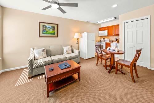 a living room with a couch and a table at Cozy 1st floor condo with golf course view in New Bern