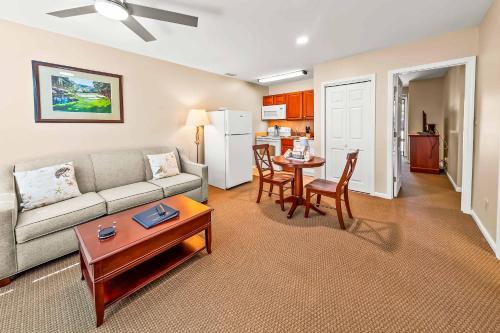 a living room with a couch and a table at Cozy 1st floor condo with golf course view in New Bern