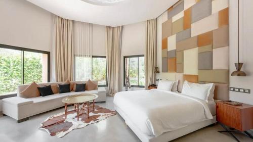 a bedroom with a large bed and a couch at Dreamcation Villa in Marrakesh