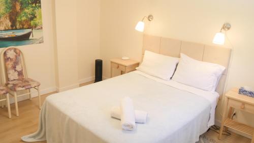 a bedroom with a bed with two towels on it at Applewood Gardens Apartment in Mississauga