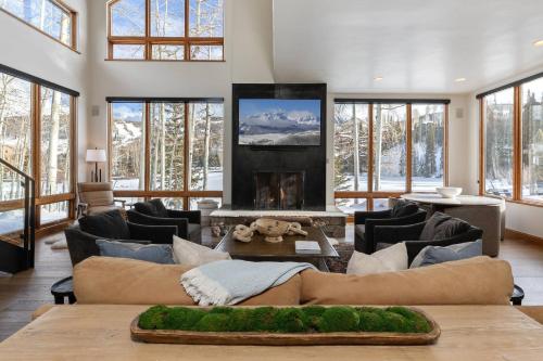 a living room with a couch and a fireplace at Benchmark Dr 101 in Telluride