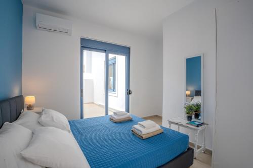 a bedroom with a bed with two towels on it at Villa Salomon- Seafront Villa with Private Pool in Plaka
