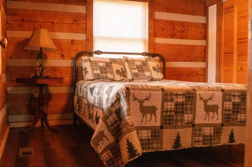 a bedroom with a bed with a quilt with deer on it at Ivy Retreat in Sevierville