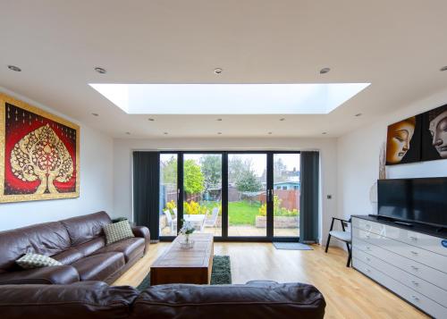 a living room with a couch and a tv at Transvaal House Ely in Ely