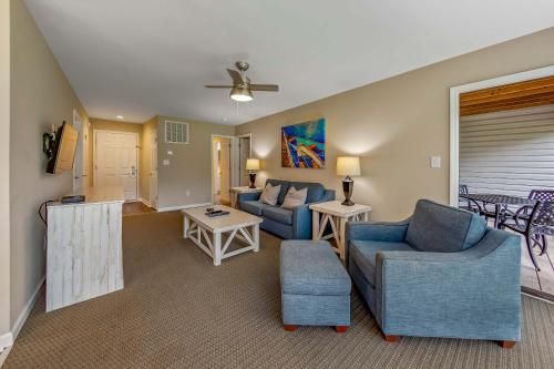 a living room with a couch and chairs and a table at Golf Course Condo with Pools & Family Fun in New Bern