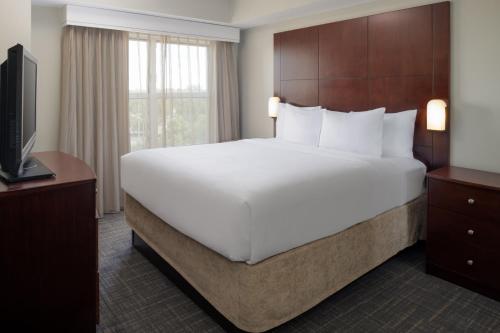 a bedroom with a large bed and a television at Residence Inn by Marriot Clearwater Downtown in Clearwater