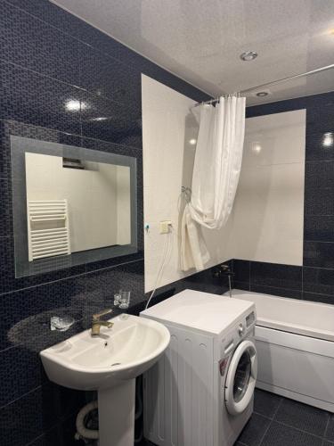 a bathroom with a sink and a washing machine at Afyan's guest house in Yerevan