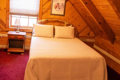 a bedroom with a large bed in a wooden room at Lover's Leap in Sevierville